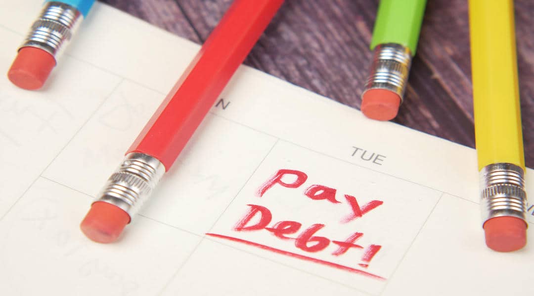 Close up of pay debt word on calendar