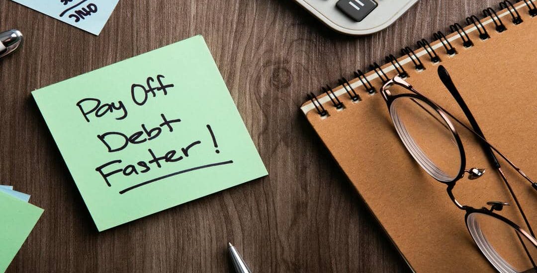 Paying Off Debt Faster Concept on Wood Background