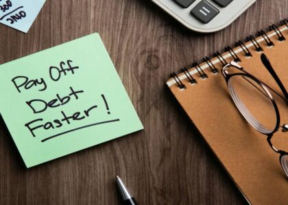 Paying Off Debt Faster Concept on Wood Background