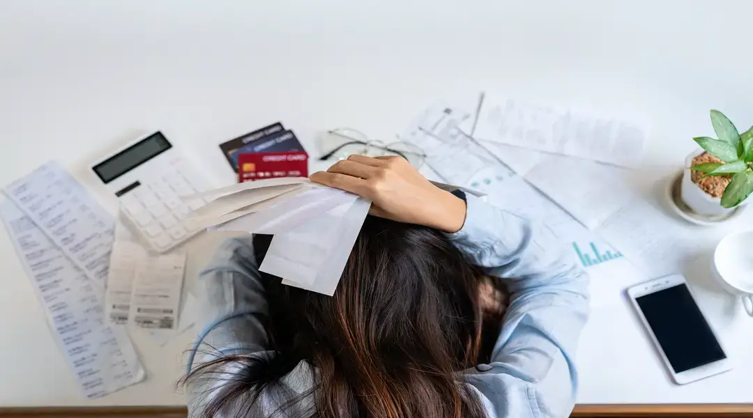 Woman Stressed with Receipts and Credit Cards